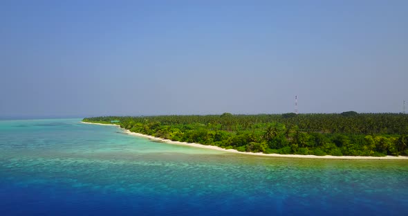 Natural flying abstract shot of a sandy white paradise beach and blue ocean background in colorful 4