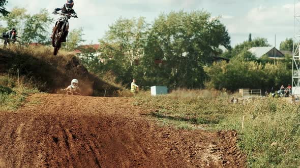 Motocross Racers Fly Over Jump, Slow Motion