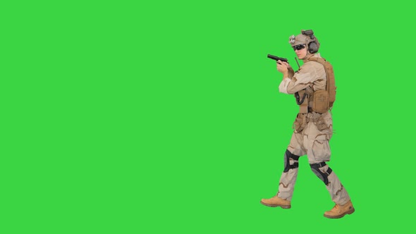 Soldier Walking Aiming with a Pistol and Shooting To Camera on a Green Screen Chroma Key