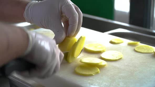 Cutting potatoes finely in close-up shot