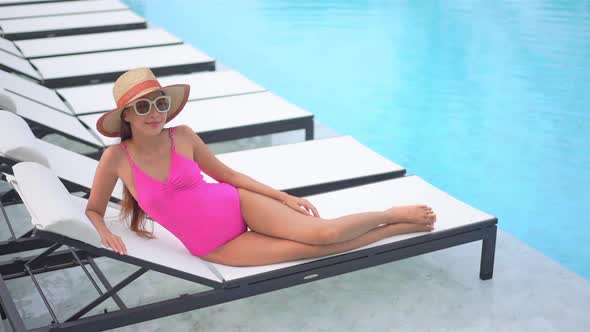 Young asian woman enjoy around outdoor swimming pool for leisure