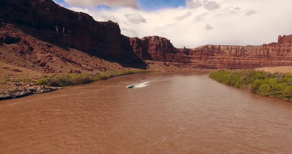 A Vessel Maneuvering Along the Muddy Shallow Waters of Colorado River.