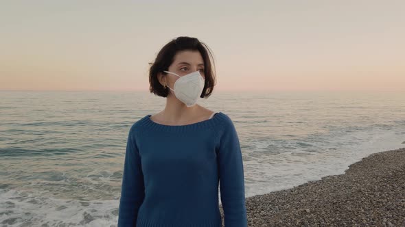 Girl with mask by the ocean