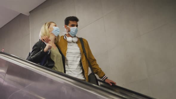 Caucasian couple on the go wearing a coronavirus covid19 mask