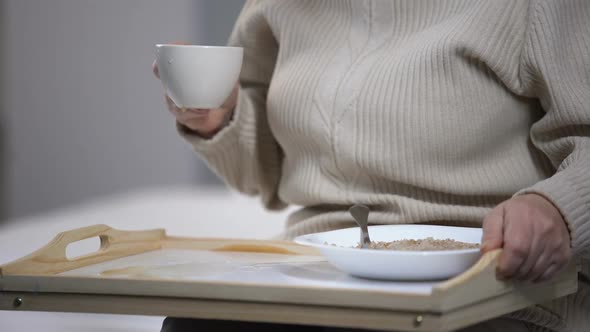 Nursing Home Employee Criticizing Elderly Female Patient Spilling Water on Tray