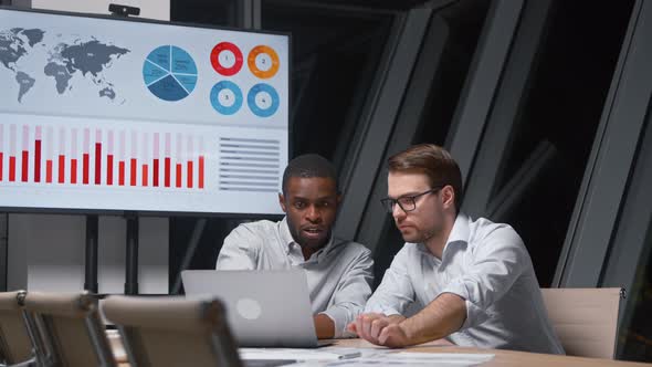 Young professional men working using computer technology in metting room