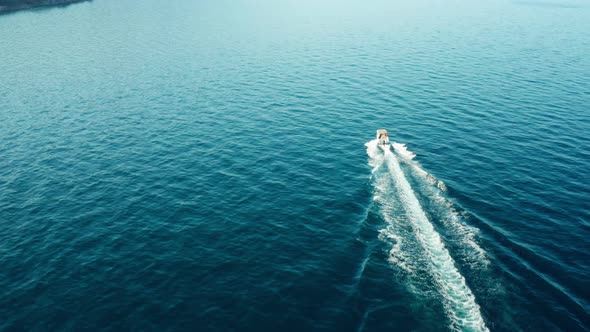 Drone View of a White Boat Sailing in the Blue Sea