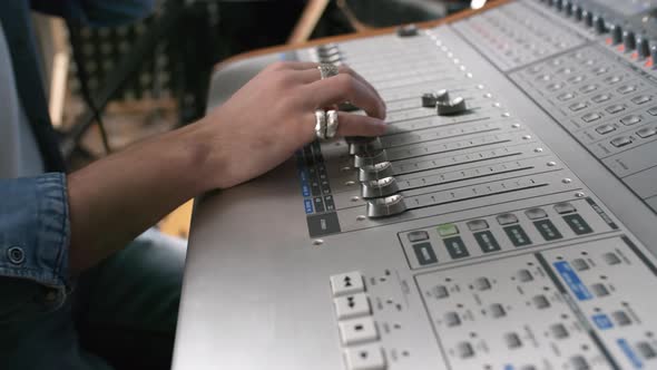 Hands of Sound Engineer Mixing Music