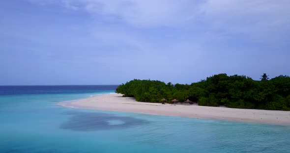 Beautiful flying tourism shot of a white sandy paradise beach and aqua blue water background in hi r