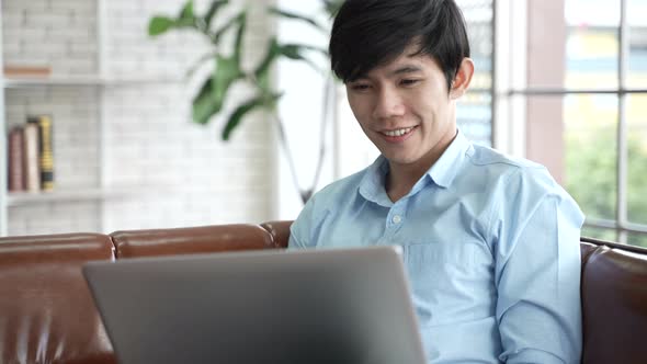 young Asian person working business on laptop at home, businessman working from home on cyberspace