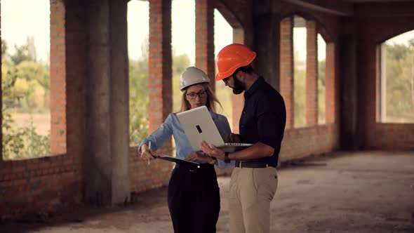 Two Engineer In Helmet Inspecting Building. Builder Contractor Specialist Read Home Plan Scheme.