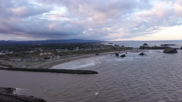 Aerial view of jetties and little fishing town of Bandon, Oregon at dawn.