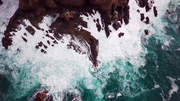 Ocean Waves at Base of Huge Cliff in Big Sur, Overhead Drone Reveal