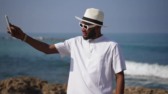 Portrait of Happy African American Tourist Taking Selfie at Picturesque Mediterranean Seascape