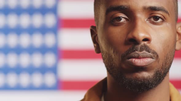 Black American Citizen Posing on U.S. Flag