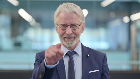 Portrait of Old Businessman Pointing at Camera Inviting