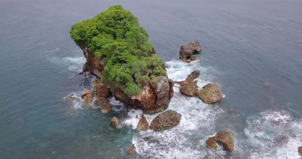 top view of waves breaking on rocks. close shot then close away. Jungwok Beach Gunung Kidul Regency,