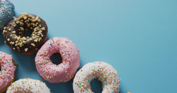 Video of donuts with icing on blue background