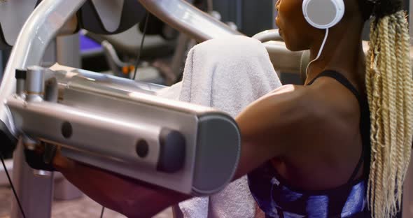 Fit woman exercising on a machine