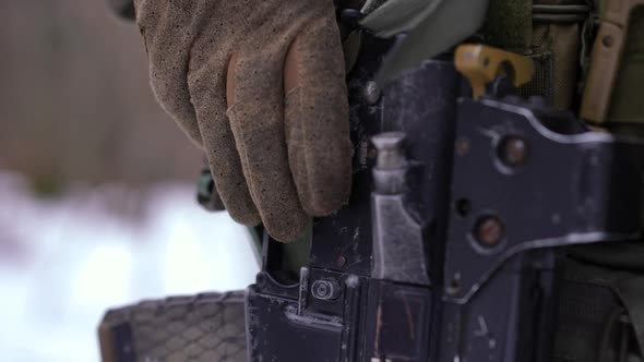 Pedestal Shot Closeup of Armed Gun with Ukrainian Soldier in Winter Forest Outdoors