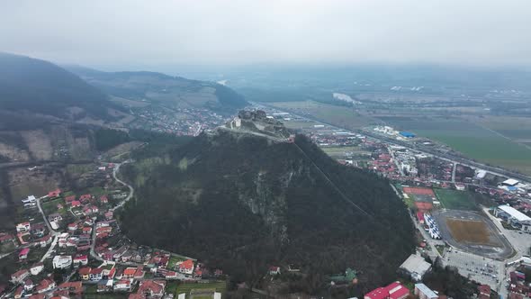 Stunning Aerial View of the Medieval Stone Fortress of Deva on a Cloudy Day