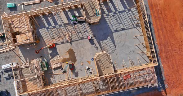 Aerial View Wood Frame Building of Beams Under Construction with Foundation