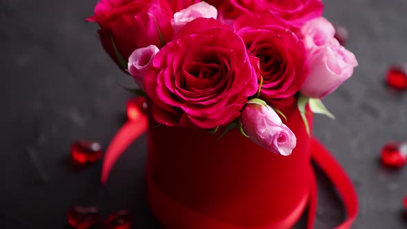 Pink Roses Bouquet Packed in Red Box and Placed on Black Stone Background