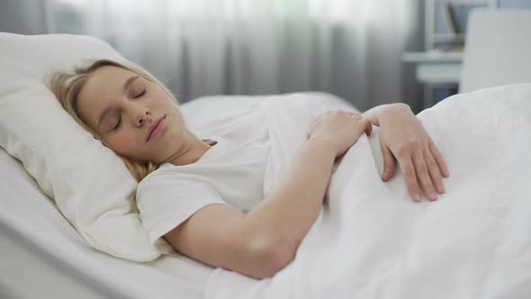 Teenage Girl Stretching Herself Waking Up After Sleep on Orthopedic Mattress
