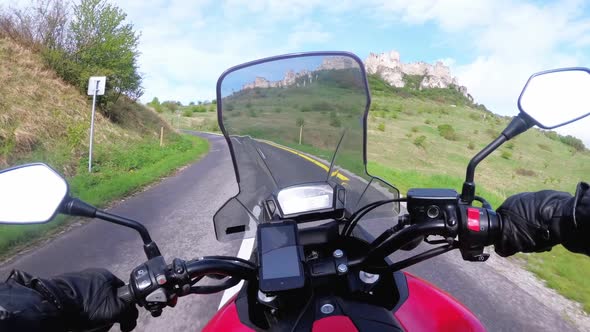 Motorcyclist Riding on the Road Near Spiss Castle. Spissky Hrad. Slovakia