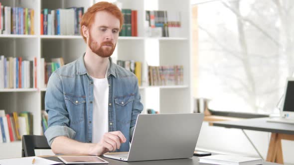 Pensive Casual Redhead Man Thinking at Work