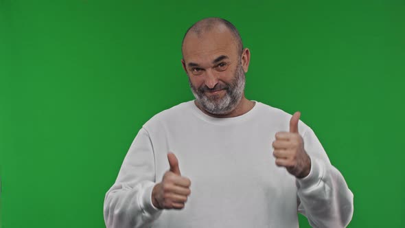 A Man Enthusiastically Shows a Thumb Up with Both Hands