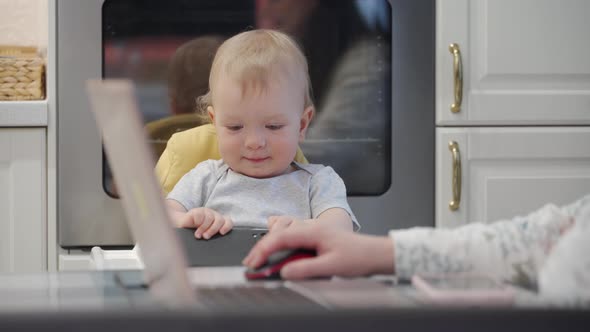 Woman with Baby Working at Home