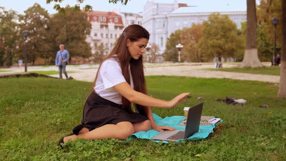 Attractive Girl Using Computer Outdoors