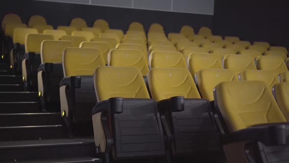 Wide Shot of Empty Cinema Hall with Rows of Yellow Chairs. No People in Movie Theatre. Luxurious