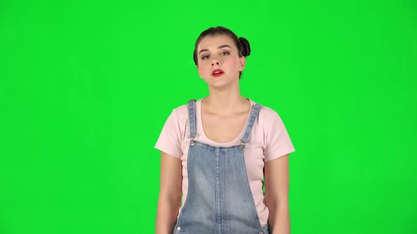 Girl Screams Calling Someone on a Green Screen at Studio