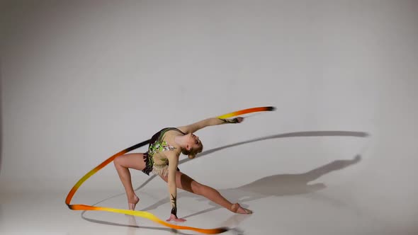 Rhythmic Gymnast Sit on One Leg on the String. White Background