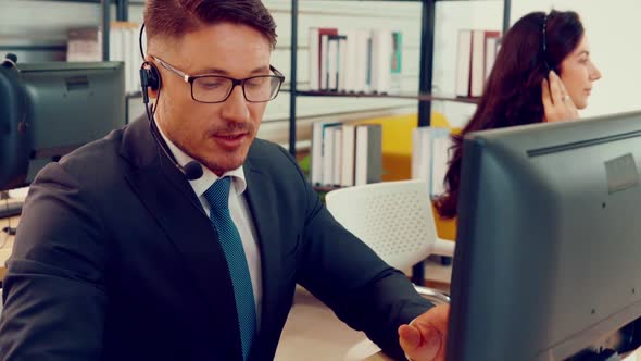 Business People Wearing Headset Working in Office