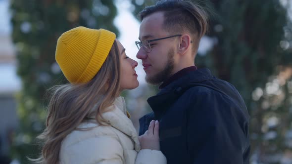 Side View of Loving Couple Rubbing Noses Smiling Turning to Camera