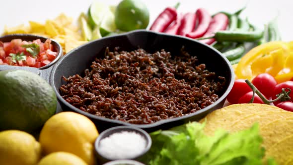 Ingredients for Chili Con Carne in Frying Iron Pan on White Wooden Table