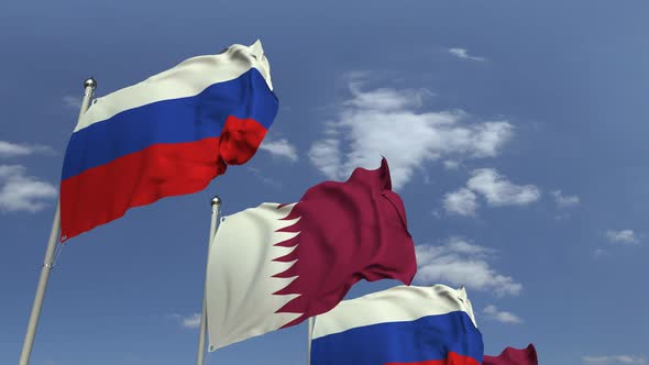 Row of Waving Flags of Qatar and Russia alt