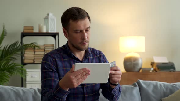 Man Holding Credit Card Makes Purchases Online Purchase Tablet Computer Payment