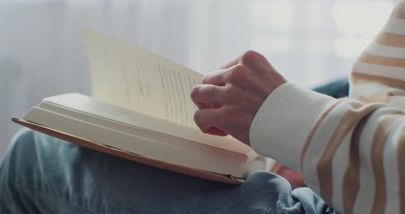 Closeup of Woman Reading a Book in Cozy Living Room