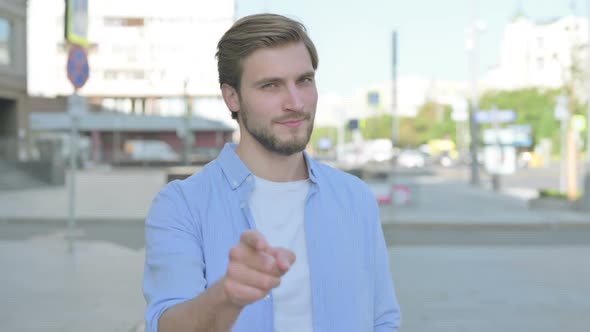 Man Pointing at the Camera Outdoor