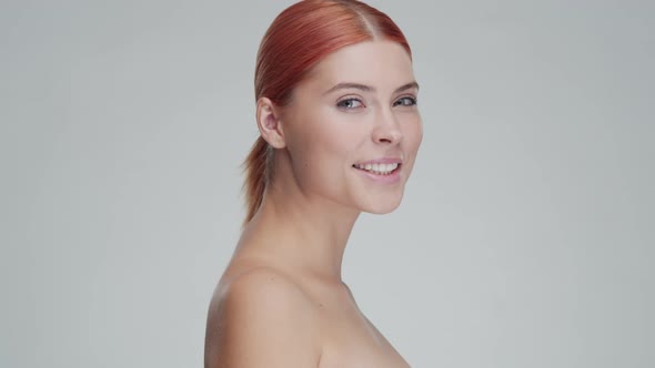 Studio portrait of young, beautiful and natural redhead woman. Beauty concept.