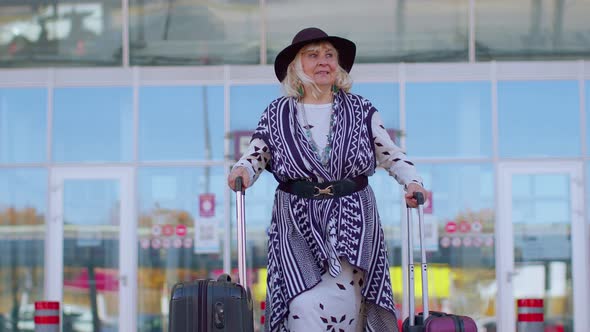 Senior Pensioner Tourist Grandmother Business Woman Walking From Airport Hall Gate with Luggage Bag