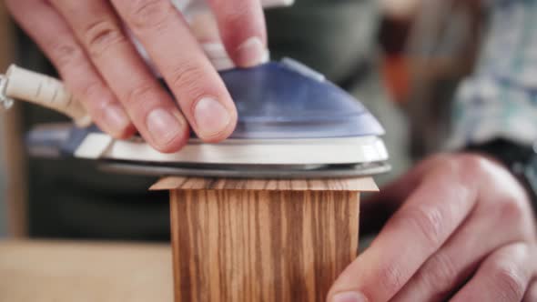 Close Up of Craftsman Hands Sanding the Surface of Handmade Wooden Box with Abrasive Paper Man