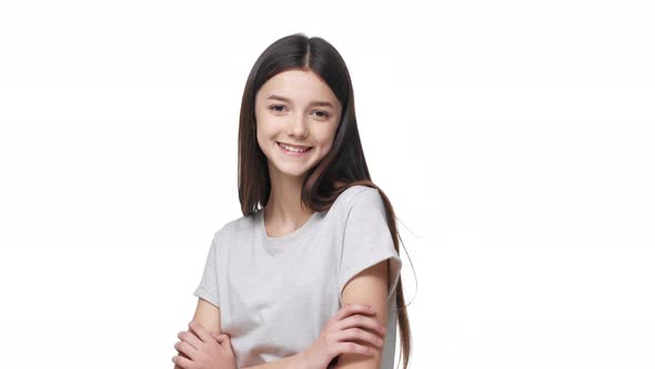 Portrait of Attractive Modest Woman 18 Years Old Smiling and Posing with Arms Crossed and Shy Look