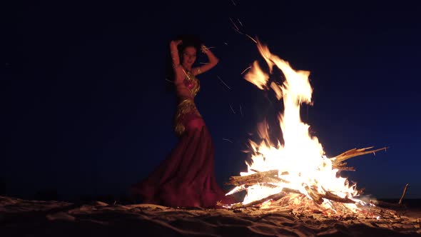 Dancer in Special Clothes Is Dancing Belly Dancing, Near the Fire