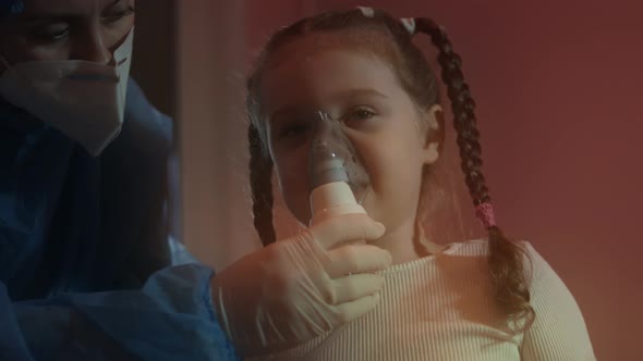 Beautiful Little Girl Makes Inhalation Using a Compressor Inhaler at Hospital