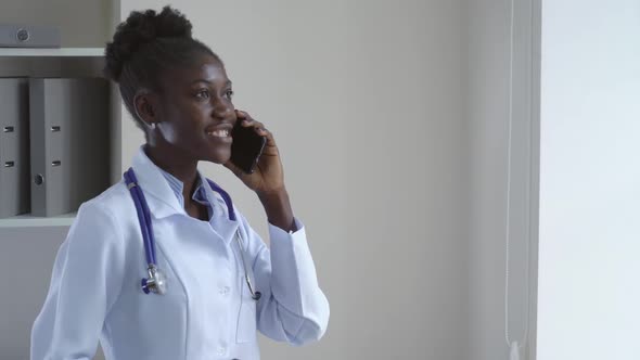 Afro American Doctor Using Smartphone.